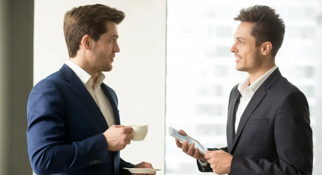 featured image of two men speaking in english